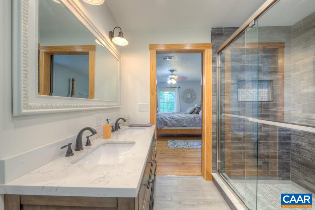 1877 Swift Run Road Ruckersville, VA 22968 - Photo 23 of 40 a bathroom with a sink and a mirror