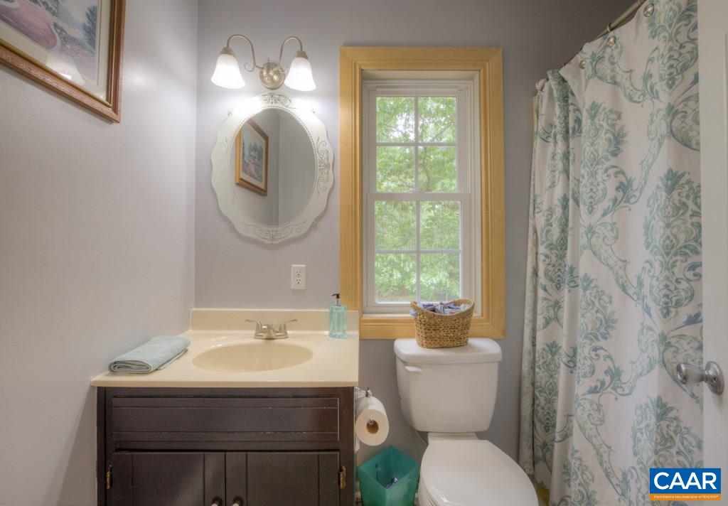 1877 Swift Run Road Ruckersville, VA 22968 - Photo 24 of 40 a bathroom with a toilet sink and mirror