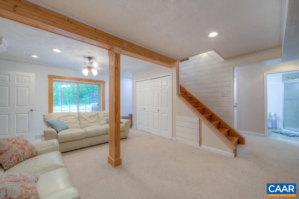 1877 Swift Run Road Ruckersville, VA 22968 - Photo 31 of 40 a living room with furniture and stairs
