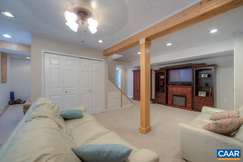 1877 Swift Run Road Ruckersville, VA 22968 - Photo 32 of 40 a living room with furniture and a ceiling fan