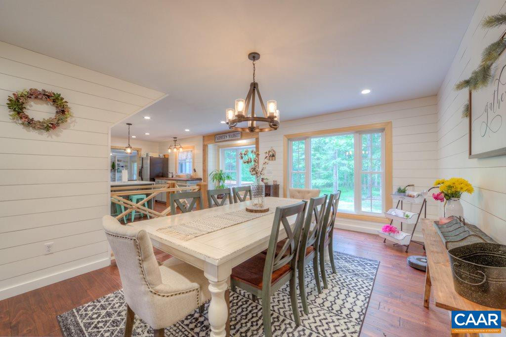 1877 Swift Run Road Ruckersville, VA 22968 - Photo 6 of 40 a dining room with furniture a chandelier and wooden floor