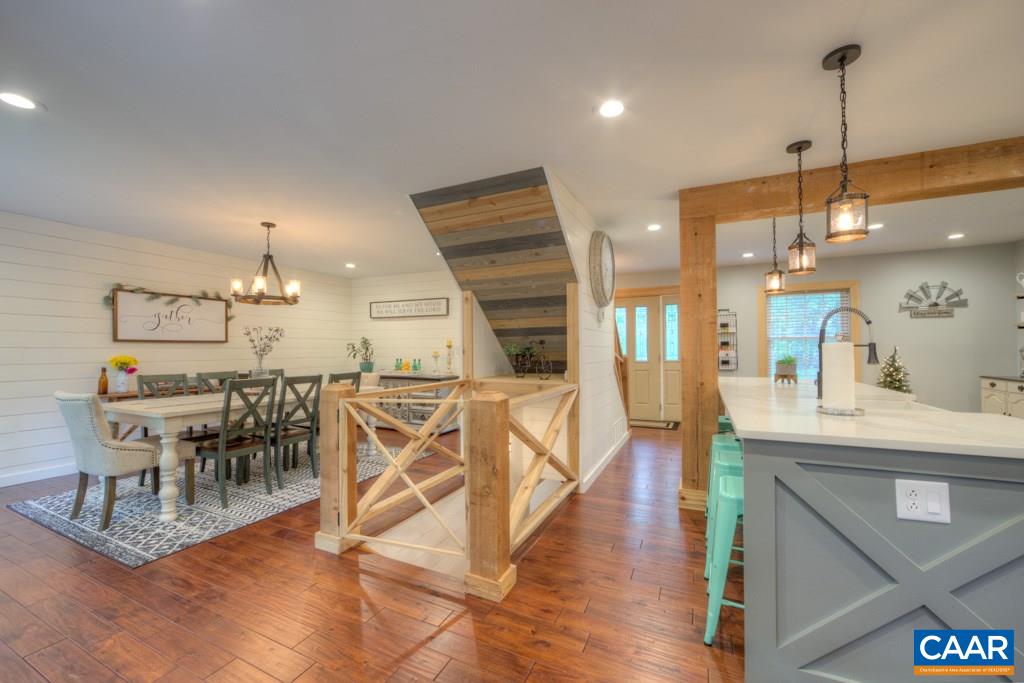 1877 Swift Run Road Ruckersville, VA 22968 - Photo 7 of 40 a view of a dining room and livingroom with furniture wooden floor a chandelier