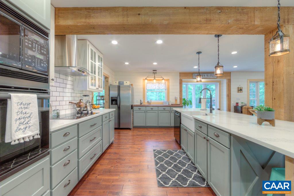 1877 Swift Run Road Ruckersville, VA 22968 - Photo 10 of 40 a large kitchen with stainless steel appliances kitchen island granite countertop a sink and cabinets