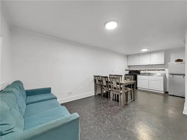 a living room with furniture and kitchen view