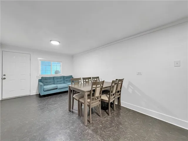 a view of a dining room with furniture and window