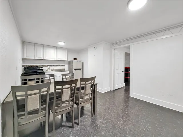a view of a kitchen with kitchen island and stainless steel appliances