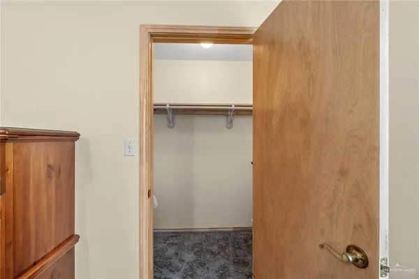 an empty room with a ceiling fan and a window