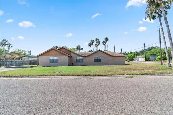 an aerial view of a house with a yard and lake view