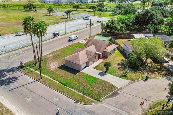 an aerial view of a house with garden space and street view