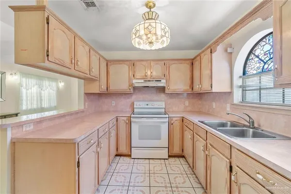 a kitchen that has a sink and a stove