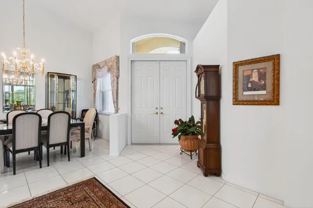 a living room with furniture a chandelier and a table