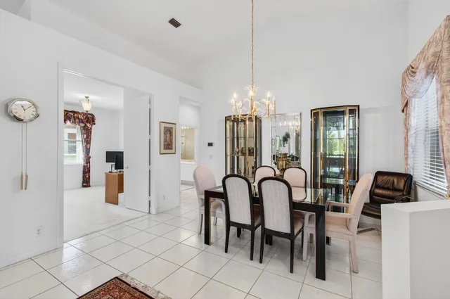 a body of water with a tree in the background