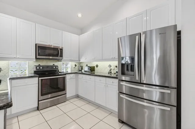 an aerial view of a house with garden space and lake view