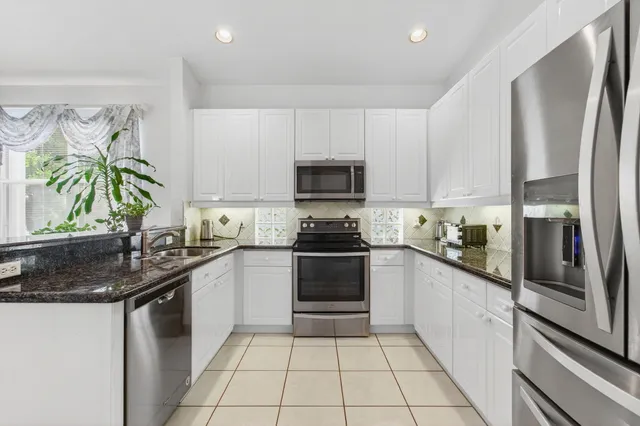 an aerial view of a houses with outdoor space and street view
