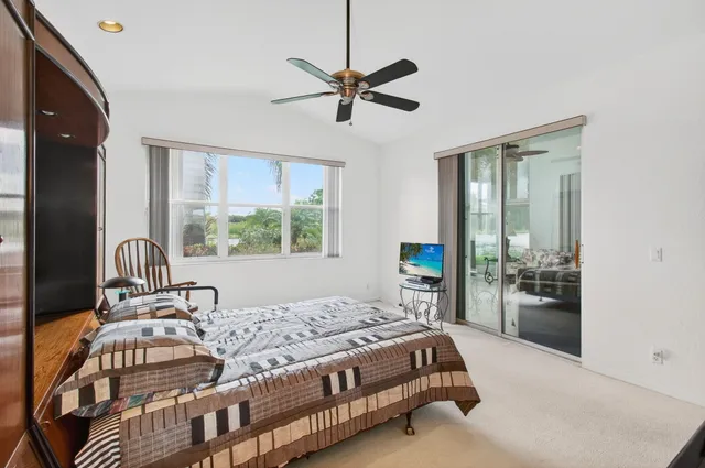 an aerial view of a residential houses with outdoor space and trees