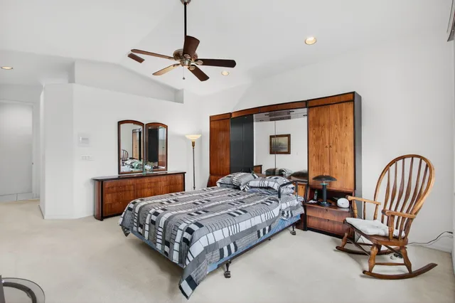 an aerial view of a house with a yard and lake view in back