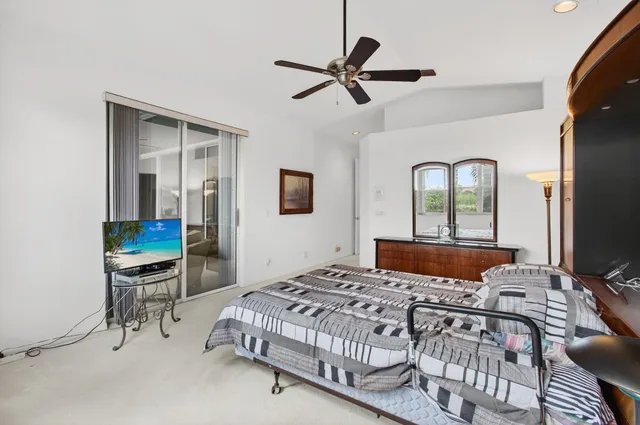 an aerial view of a residential houses with outdoor space and trees