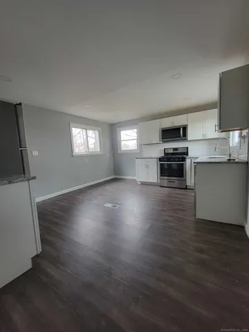 a kitchen with stainless steel appliances a refrigerator sink and stove top oven