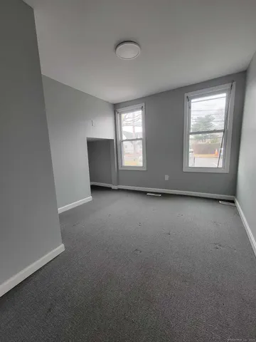 an empty room with a empty space and windows