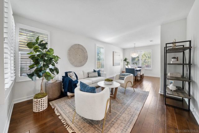 a view of a dining room with furniture wooden floor and chandelier