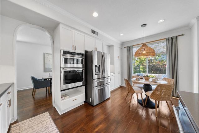 a living room with furniture a fireplace and a large window