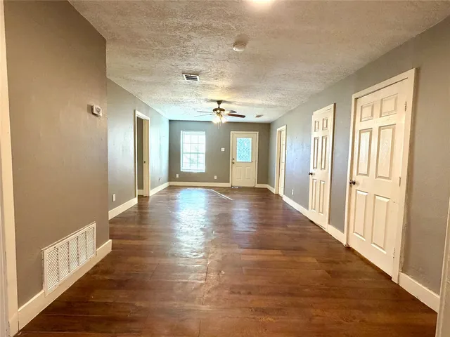 a view of an entryway with wooden floor and windows