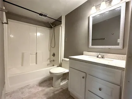 a bathroom with a sink toilet a mirror and shower