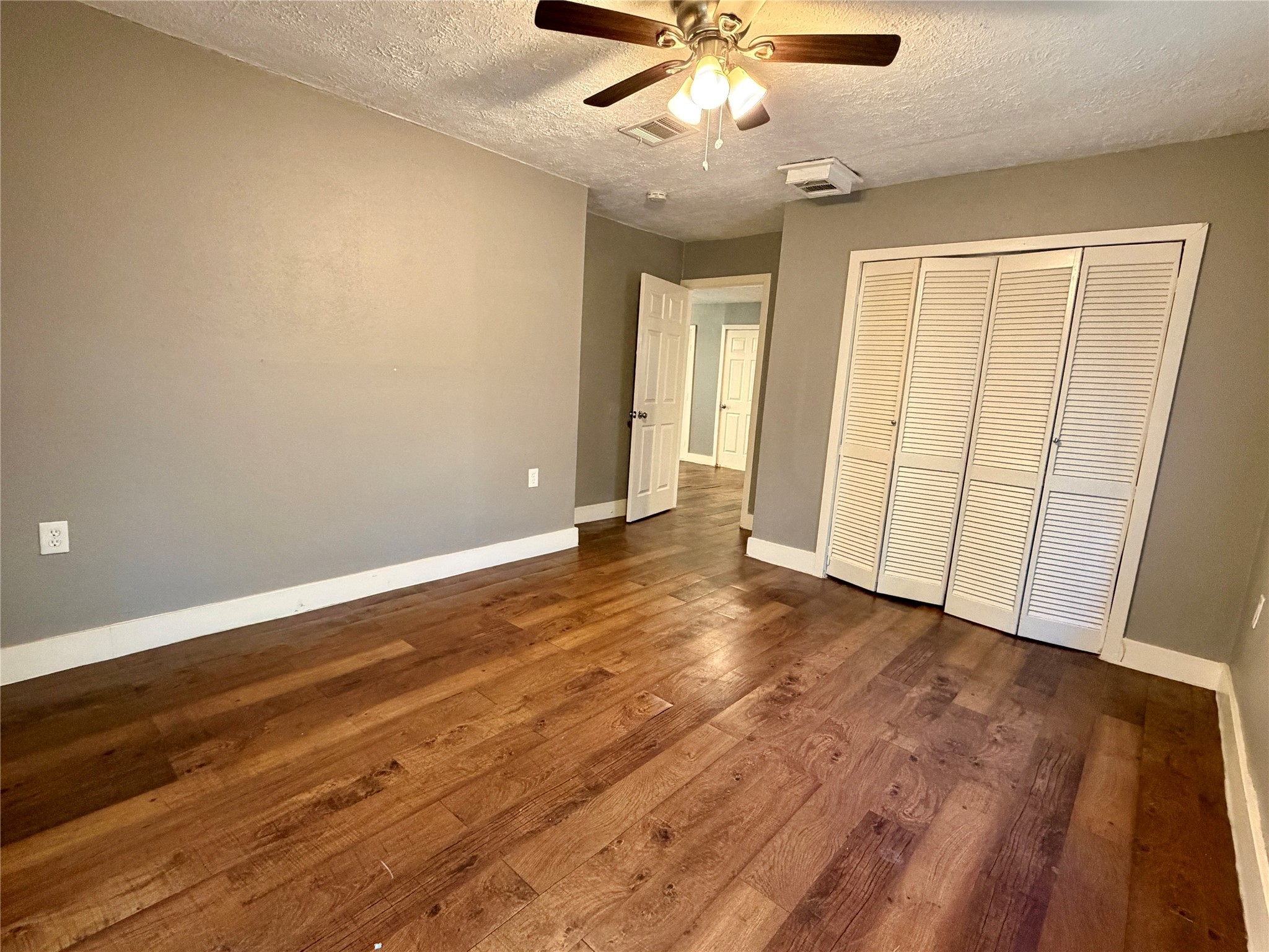4727 Eppes Street Houston, TX 77021 - Photo 10 of 16 an empty room with wooden floor and ceiling fan
