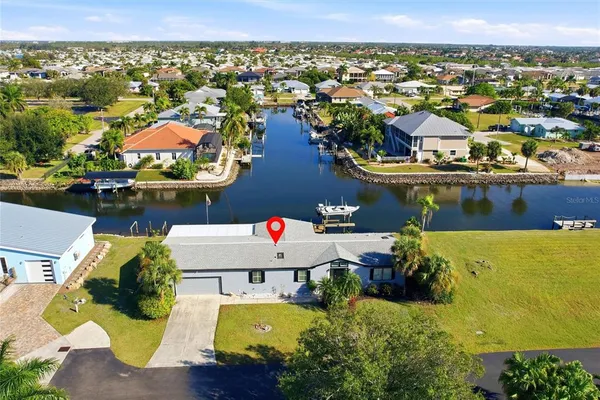 an aerial view of a house with a lake view