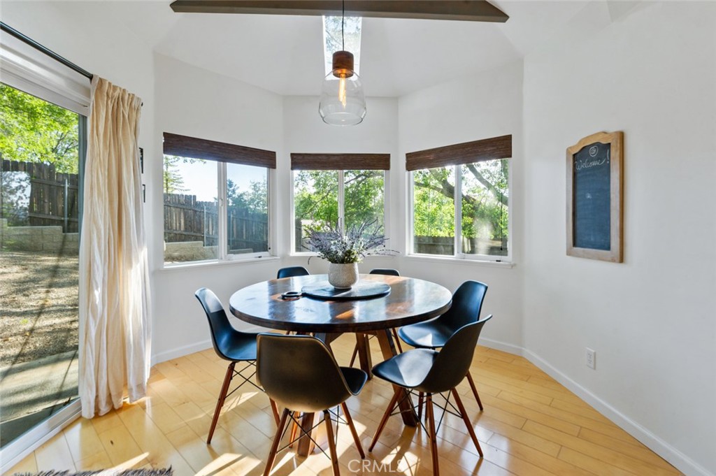 940 Highway 173 Lake Arrowhead, CA 92352 - Photo 13 of 45 a dining room with furniture a chandelier and wooden floor