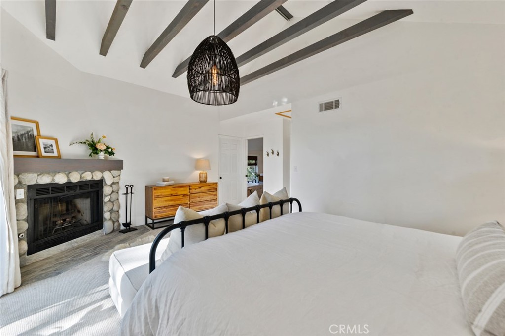 940 Highway 173 Lake Arrowhead, CA 92352 - Photo 16 of 45 a bedroom with furniture and a fireplace