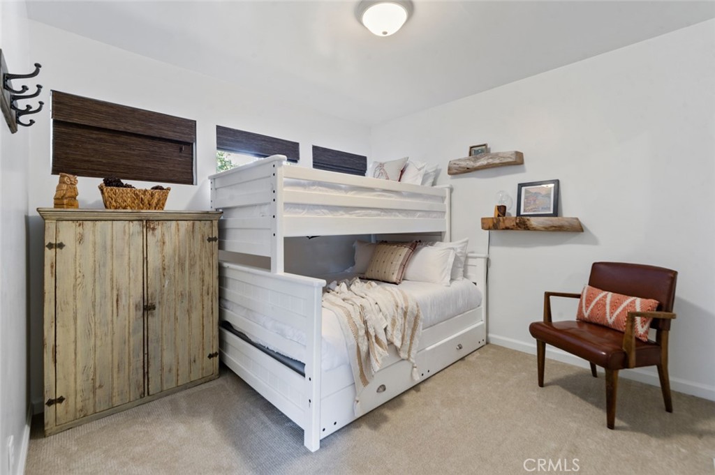 940 Highway 173 Lake Arrowhead, CA 92352 - Photo 24 of 45 a bedroom with a bed and chair