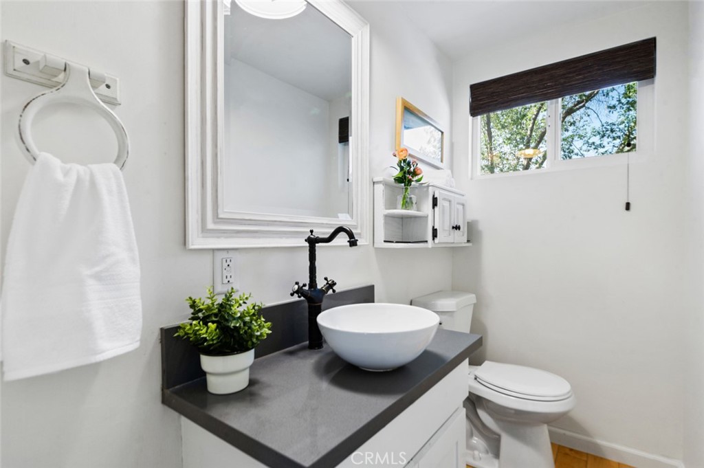 940 Highway 173 Lake Arrowhead, CA 92352 - Photo 25 of 45 a bathroom with a toilet sink and mirror