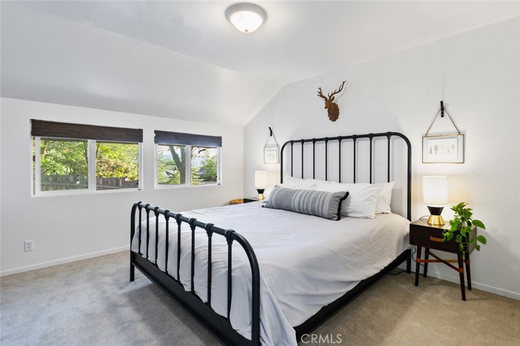 940 Highway 173 Lake Arrowhead, CA 92352 - Photo 26 of 45 a bedroom with a bed and a window