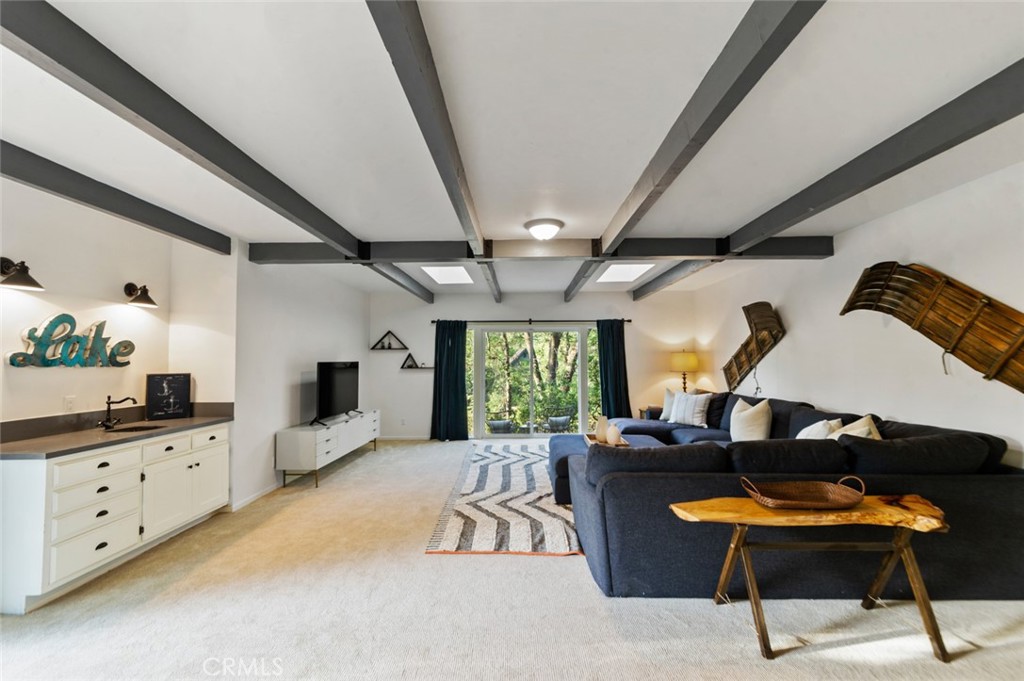 940 Highway 173 Lake Arrowhead, CA 92352 - Photo 32 of 45 a living room with furniture and windows