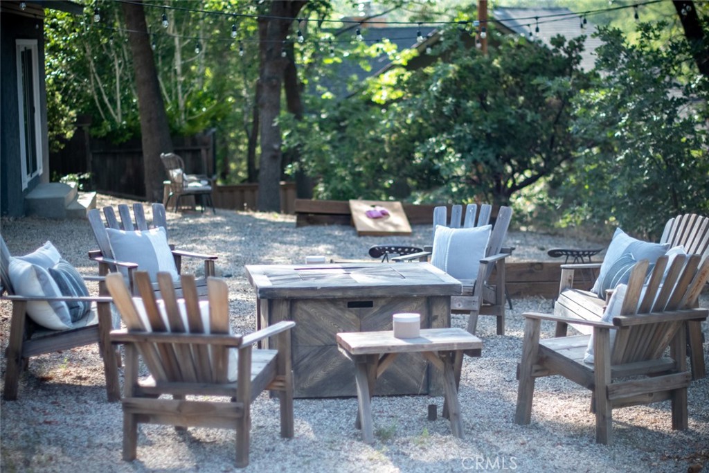 940 Highway 173 Lake Arrowhead, CA 92352 - Photo 35 of 45 a view of a dinning table and chairs in the patio