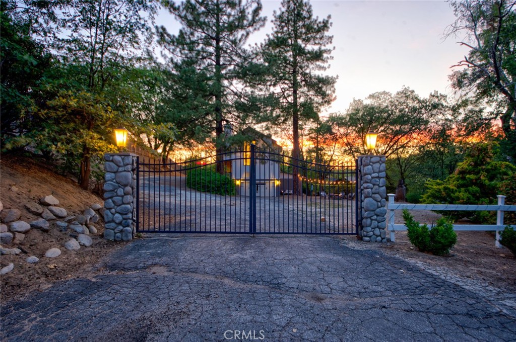 940 Highway 173 Lake Arrowhead, CA 92352 - Photo 40 of 45 a view of a backyard with large trees and wooden fence