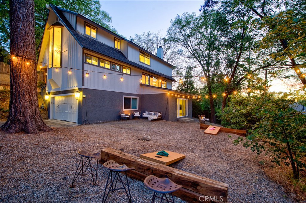 940 Highway 173 Lake Arrowhead, CA 92352 - Photo 44 of 45 a backyard of a house with barbeque oven table and chairs