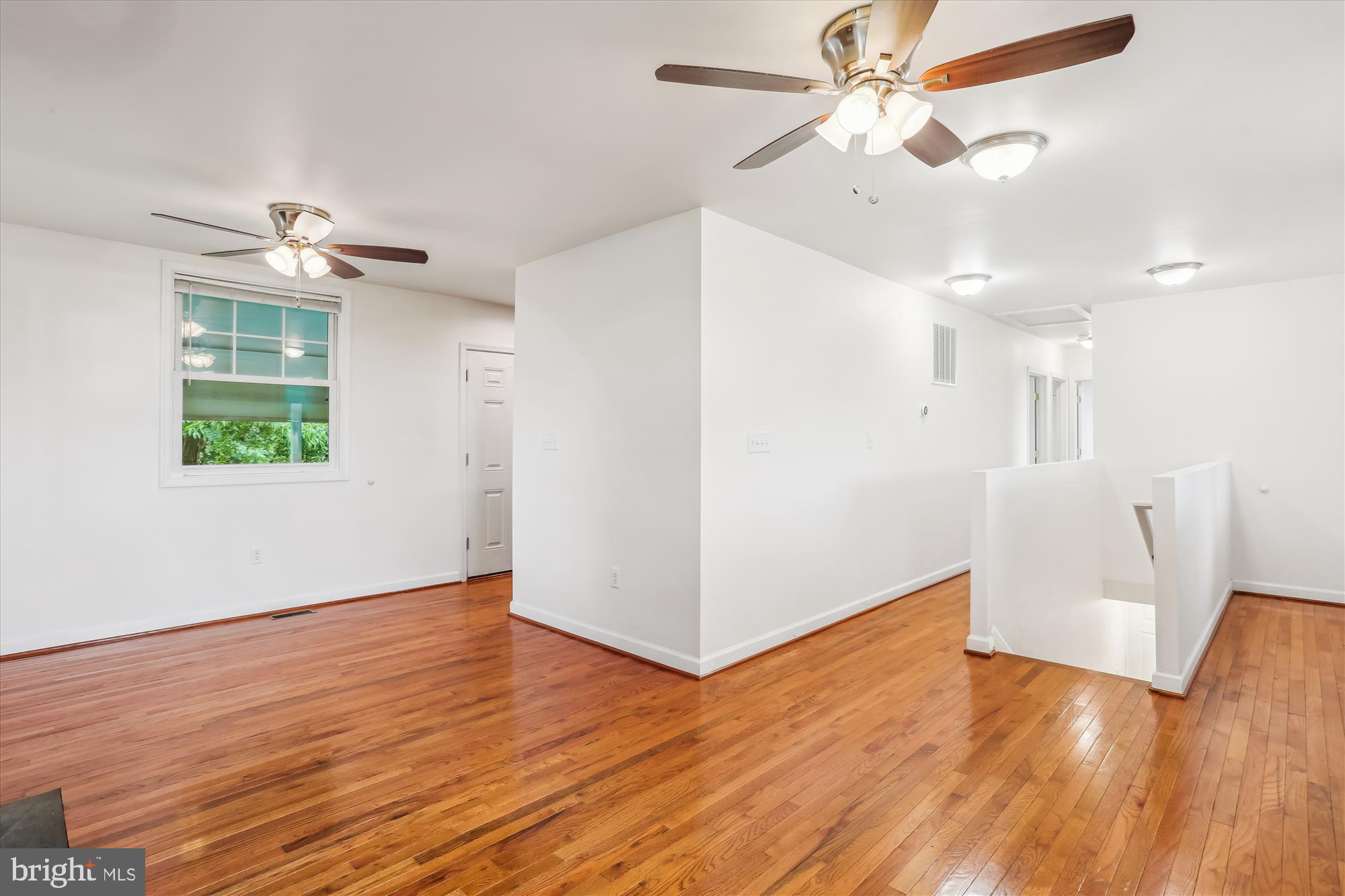 11008 Liberty Road Frederick, MD 21701 - Photo 11 of 39 a view of empty room with wooden floor and fan