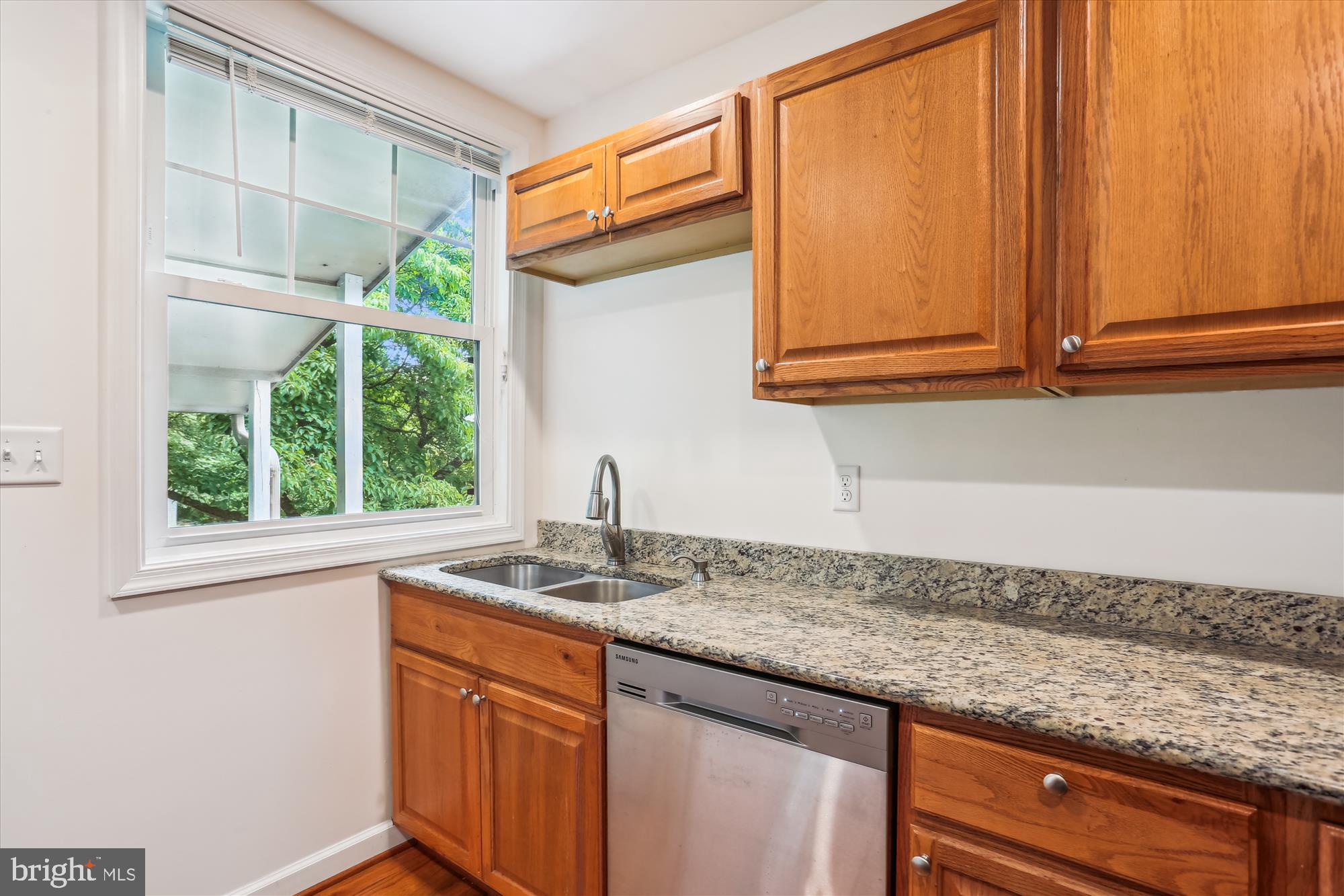 11008 Liberty Road Frederick, MD 21701 - Photo 16 of 39 a kitchen with granite countertop sink cabinets and window
