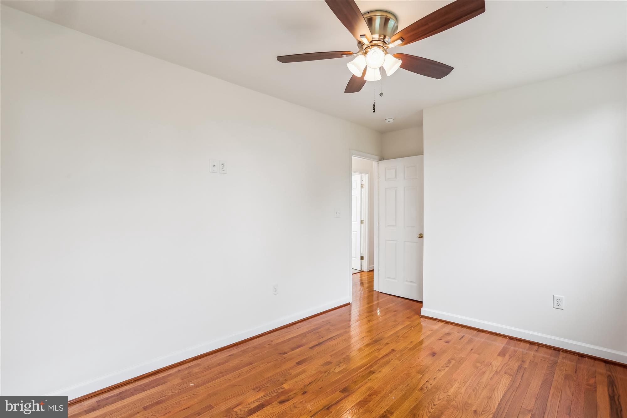 11008 Liberty Road Frederick, MD 21701 - Photo 23 of 39 an empty room with wooden floor and ceiling fan