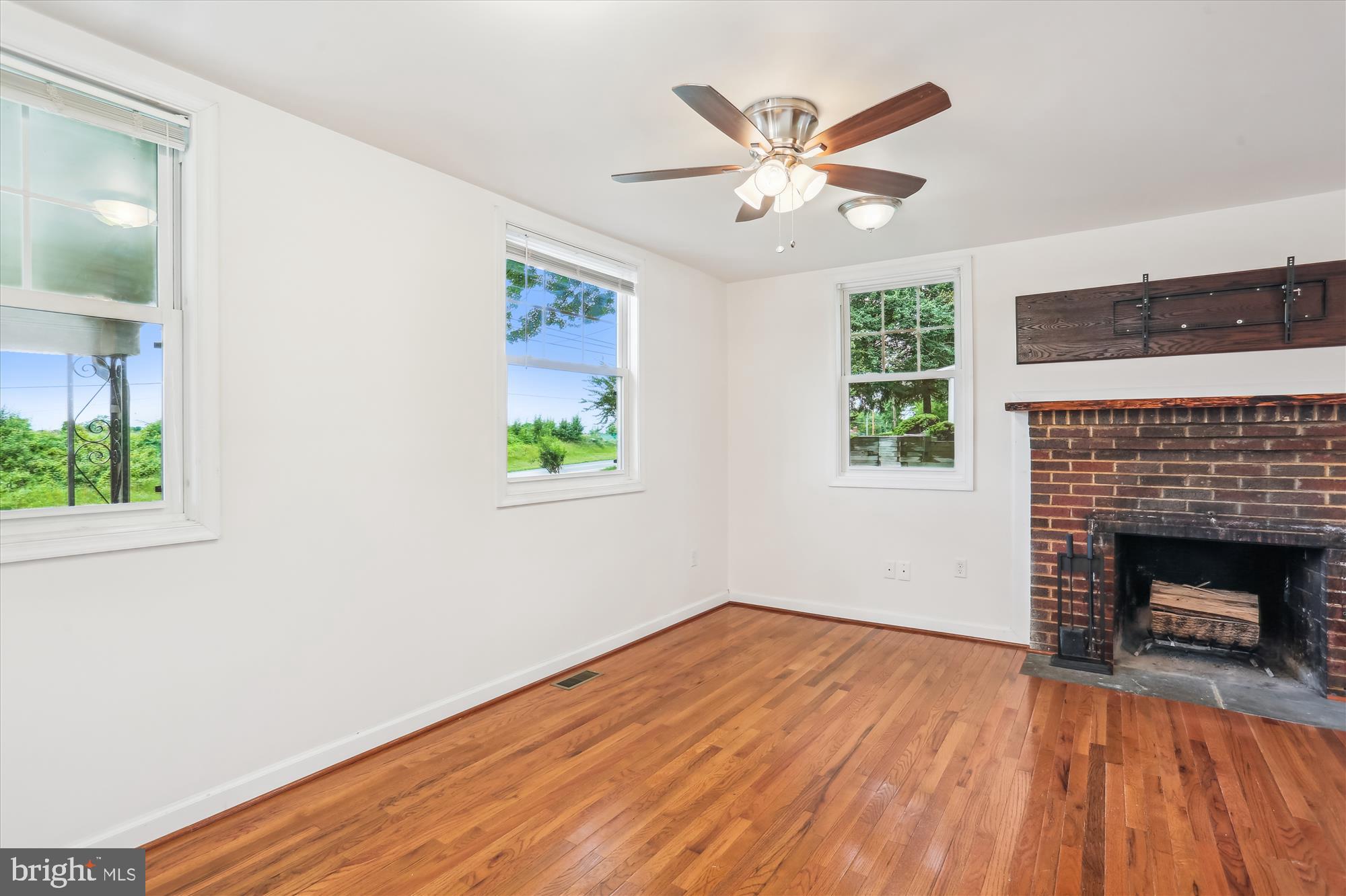 11008 Liberty Road Frederick, MD 21701 - Photo 8 of 39 a view of an empty room with wooden floor and a window