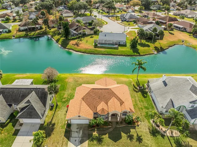 an aerial view of a house with a lake view