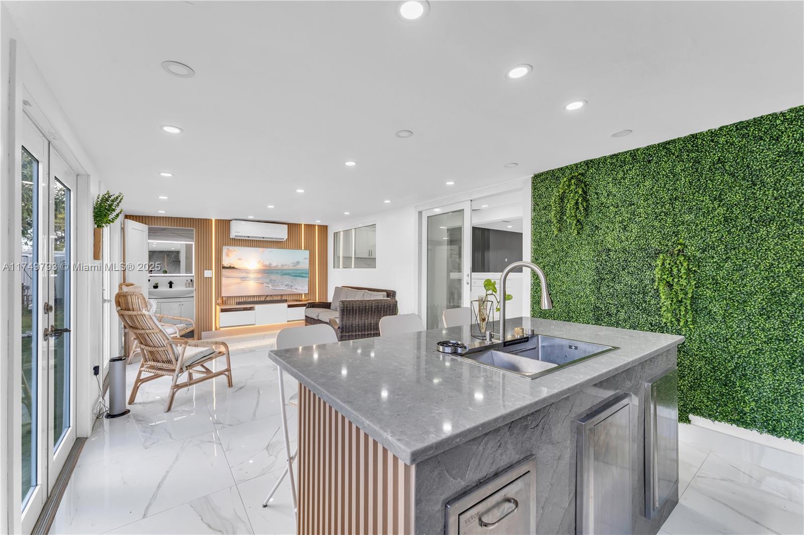 19900 Gulfstream Road Cutler Bay, FL 33157 - Photo 23 of 34 a kitchen with stainless steel appliances granite countertop tops pace a sink and a living room view
