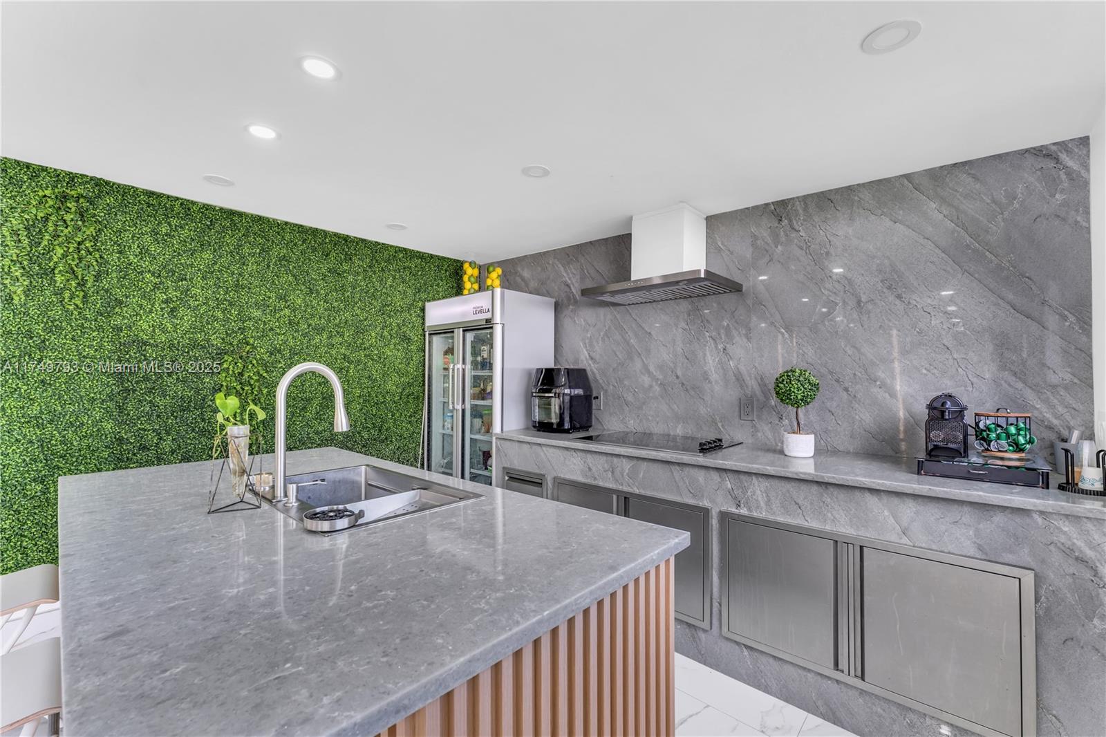 19900 Gulfstream Road Cutler Bay, FL 33157 - Photo 24 of 34 a kitchen with kitchen island granite countertop a sink a counter top space and cabinets