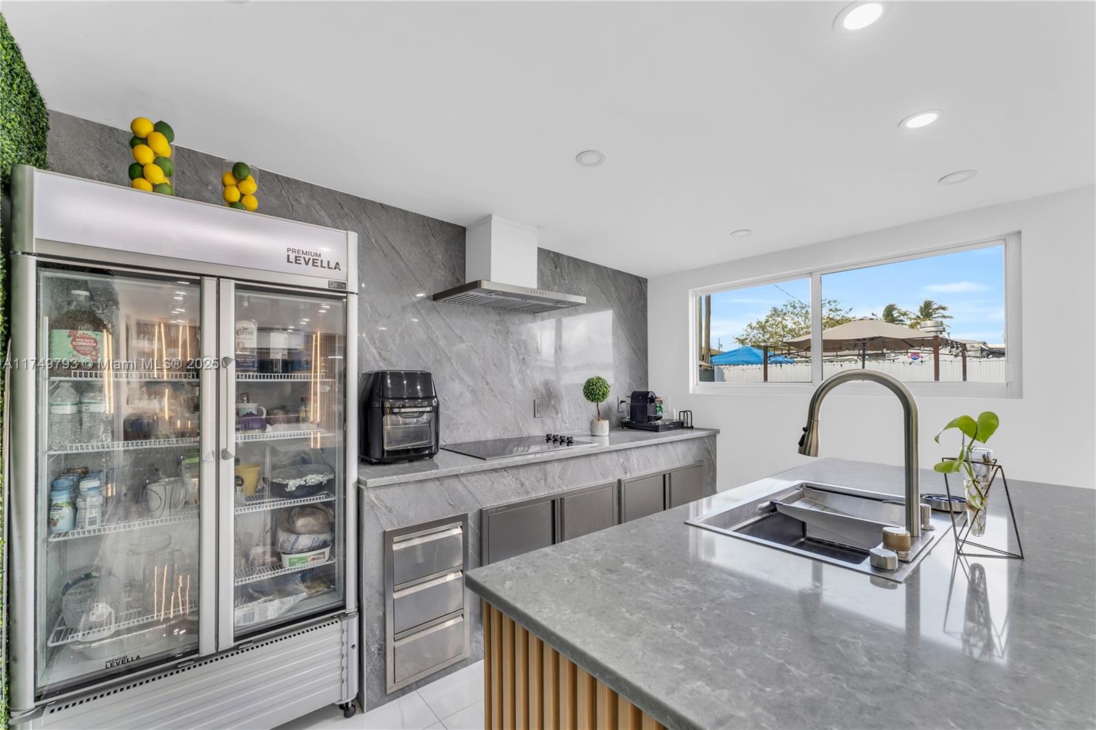 19900 Gulfstream Road Cutler Bay, FL 33157 - Photo 26 of 34 a kitchen with stainless steel appliances granite countertop a stove top oven a sink a counter space and cabinets