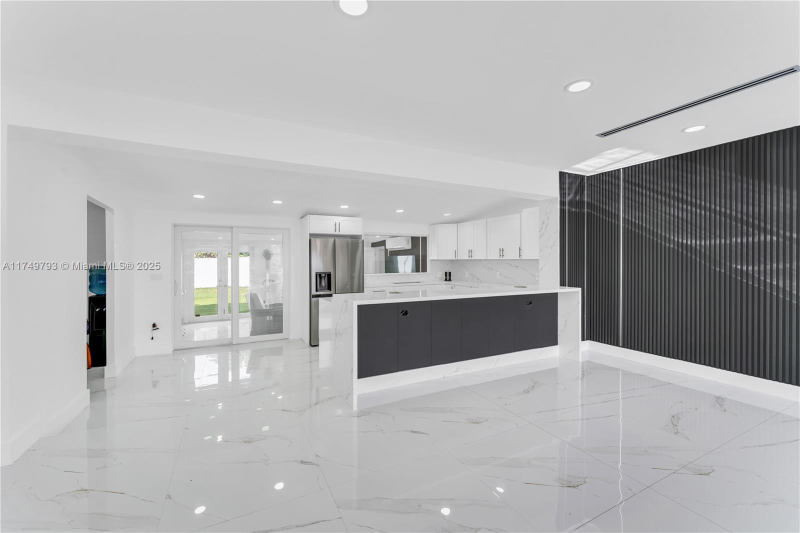 19900 Gulfstream Road Cutler Bay, FL 33157 - Photo 6 of 34 a large white kitchen with kitchen island a sink stainless steel appliances and cabinets