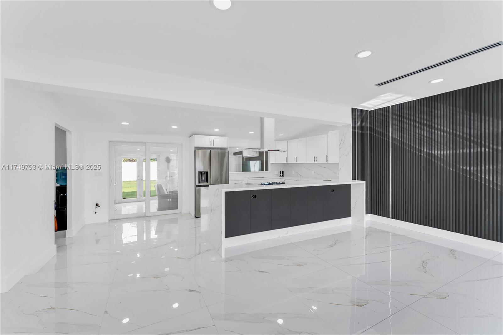 19900 Gulfstream Road Cutler Bay, FL 33157 - Photo 7 of 34 a large white kitchen with kitchen island a sink stainless steel appliances and cabinets