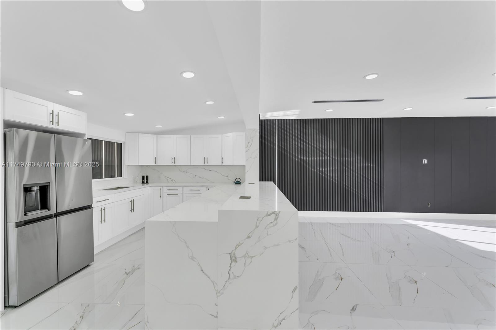 19900 Gulfstream Road Cutler Bay, FL 33157 - Photo 9 of 34 a large white kitchen with a refrigerator a stove and cabinets