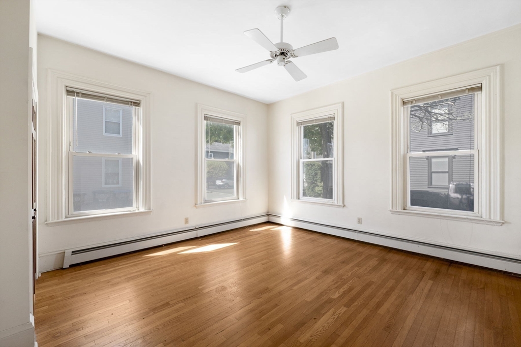 18 Briggs Street Salem, MA 01970 - Photo 14 of 43 a view of an empty room with wooden floor and a window